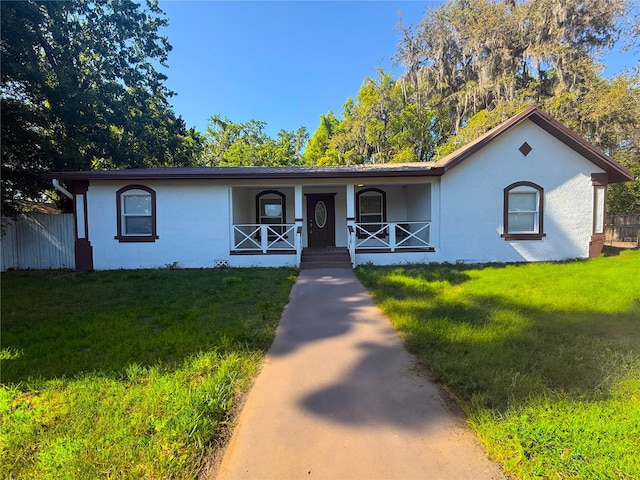 40709 Melrose Ave, Zephyrhills, FL 33540 - single story home with a porch, stucco siding, fence, and a front yard