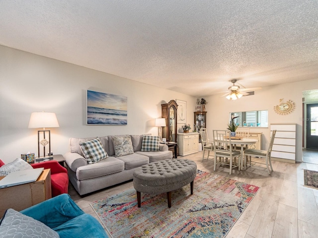 2555 Royal Pines Cir Unit A, Clearwater, FL 33763 - living area featuring ceiling fan, a textured ceiling, and light wood-type flooring