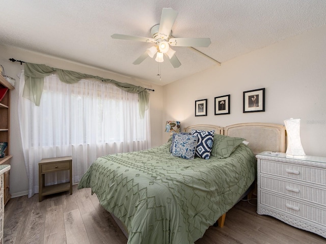 2555 Royal Pines Cir Unit A, Clearwater, FL 33763 - bedroom featuring wood finished floors, a textured ceiling, and ceiling fan