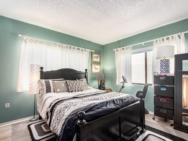 2555 Royal Pines Cir Unit A, Clearwater, FL 33763 - bedroom with a textured ceiling, wood finished floors, and a textured wall