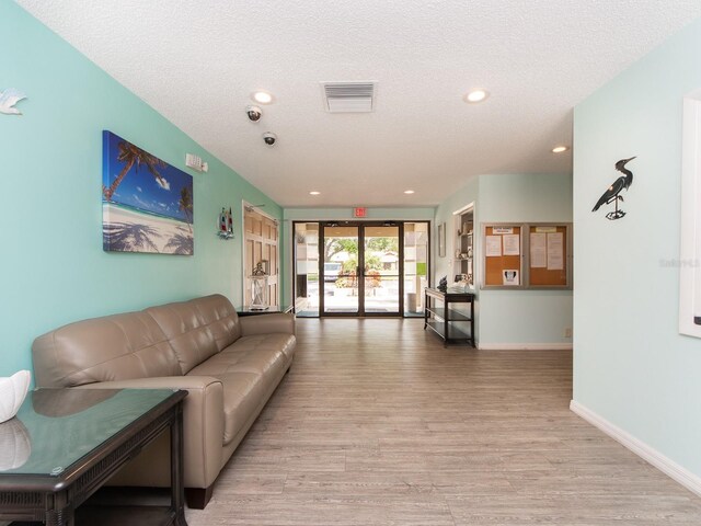 2555 Royal Pines Cir Unit A, Clearwater, FL 33763 - living room with light wood-type flooring, a textured ceiling, and recessed lighting