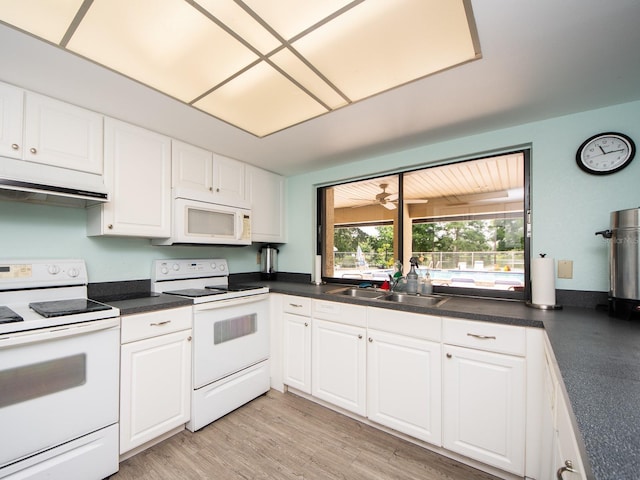 2555 Royal Pines Cir Unit A, Clearwater, FL 33763 - kitchen featuring white appliances, white cabinetry, ventilation hood, and dark countertops