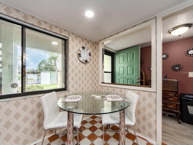 2555 Royal Pines Cir Unit A, Clearwater, FL 33763 - dining room featuring wallpapered walls and wood finished floors