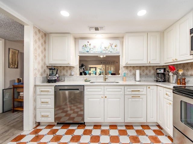 2555 Royal Pines Cir Unit A, Clearwater, FL 33763 - kitchen with appliances with stainless steel finishes, light countertops, white cabinets, tasteful backsplash, and recessed lighting