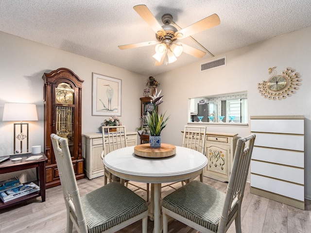 2555 Royal Pines Cir Unit A, Clearwater, FL 33763 - dining room featuring ceiling fan, light wood finished floors, and a textured ceiling