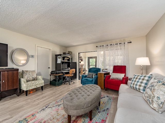 2555 Royal Pines Cir Unit A, Clearwater, FL 33763 - living area featuring wood finished floors, a textured ceiling, and french doors