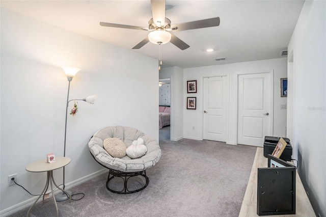 sitting room featuring baseboards, a ceiling fan, carpet flooring, and visible vents