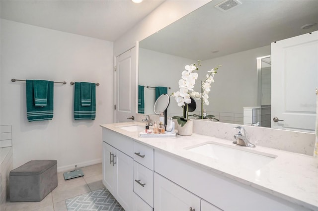 bathroom with tile patterned flooring, visible vents, a sink, and double vanity