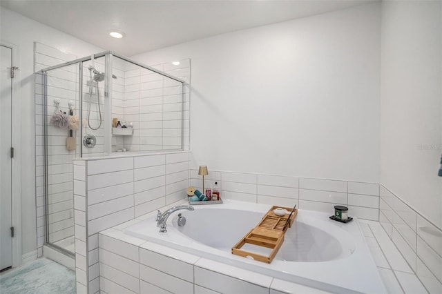 full bath featuring recessed lighting, a bath, and a shower stall