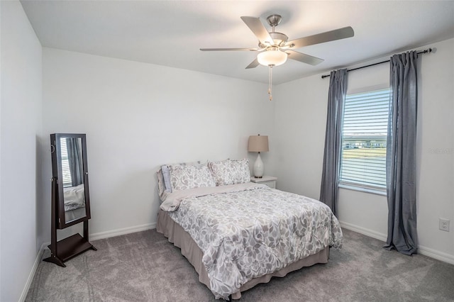 bedroom featuring ceiling fan, light carpet, and baseboards