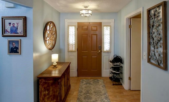 10833 96th St N, Largo, FL 33773 - foyer entrance featuring light wood-style flooring and a textured ceiling