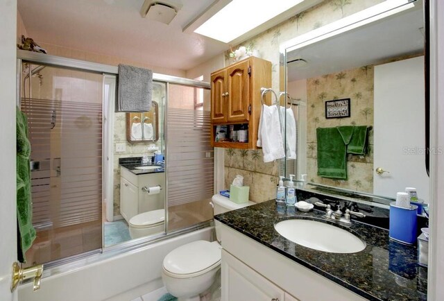 10833 96th St N, Largo, FL 33773 - full bathroom with enclosed tub / shower combo, toilet, and vanity