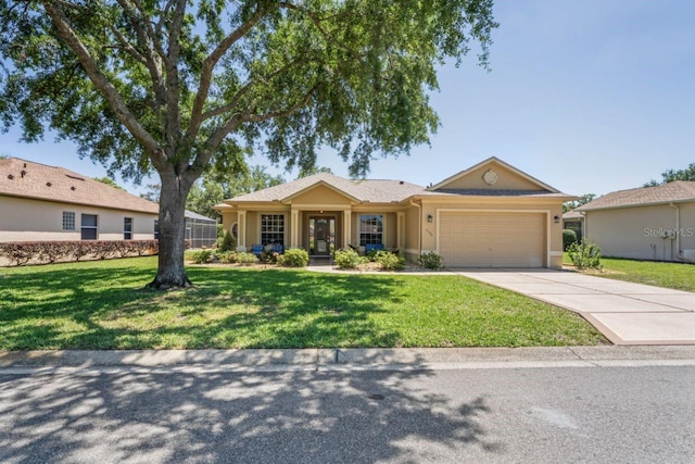 ranch-style house featuring stucco siding, a front lawn, driveway, and a garage