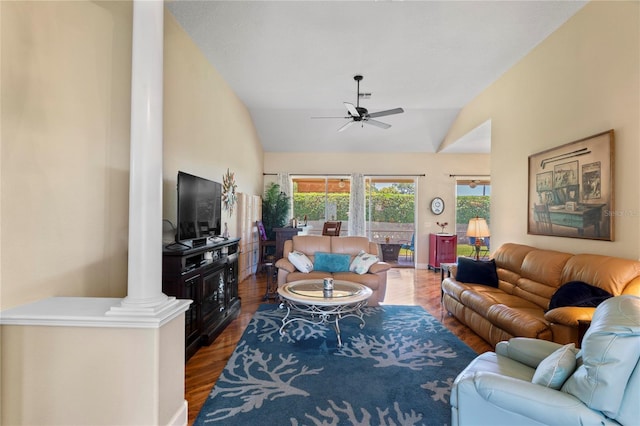 living room with ceiling fan, lofted ceiling, wood finished floors, and decorative columns