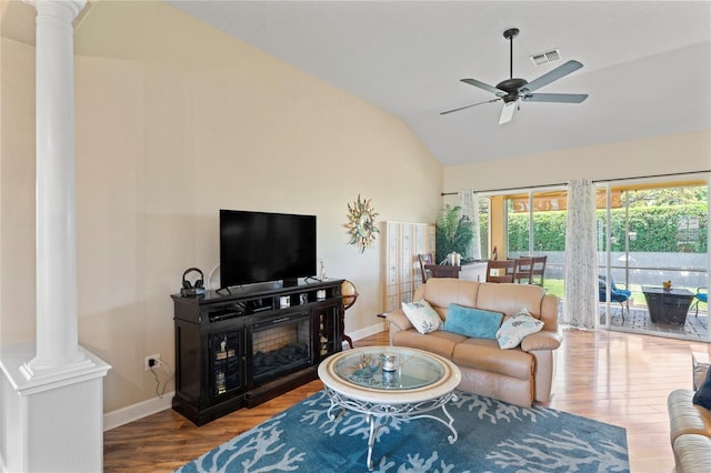living area featuring baseboards, wood finished floors, visible vents, and ornate columns