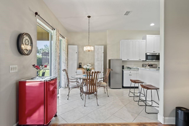 dining space with recessed lighting, a notable chandelier, visible vents, and light tile patterned floors