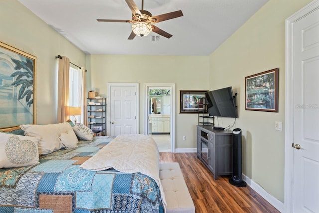 bedroom featuring baseboards, multiple windows, wood finished floors, and visible vents