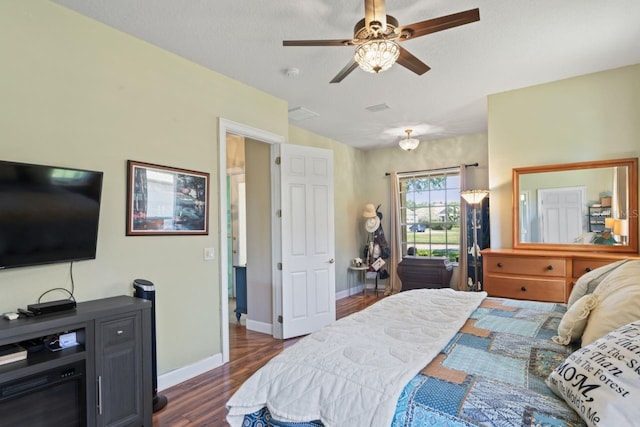 bedroom featuring visible vents, a ceiling fan, baseboards, and dark wood finished floors
