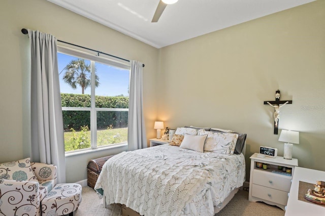 carpeted bedroom with ceiling fan and multiple windows