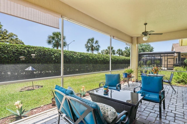 sunroom with outdoor lounge area and ceiling fan