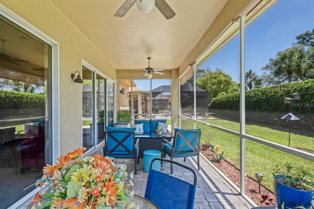 sunroom featuring outdoor lounge area and ceiling fan