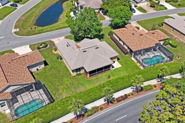 drone / aerial view with a residential view and a water view