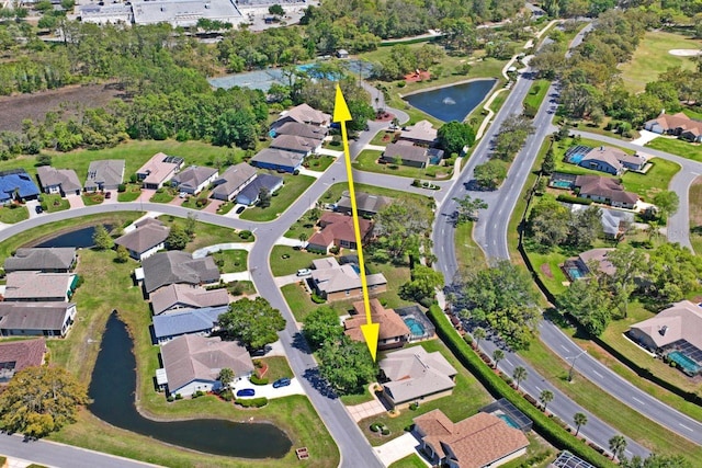 drone / aerial view featuring a residential view and a water view