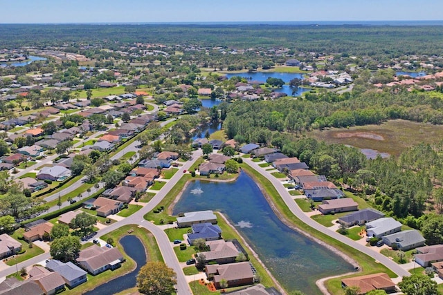 drone / aerial view with a water view and a residential view
