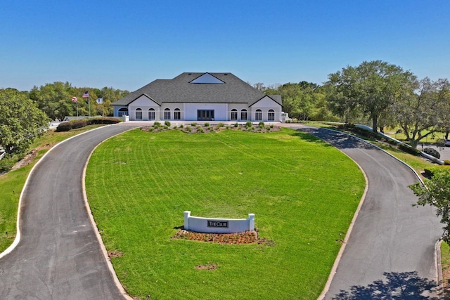 view of front facade featuring a front yard and aphalt driveway