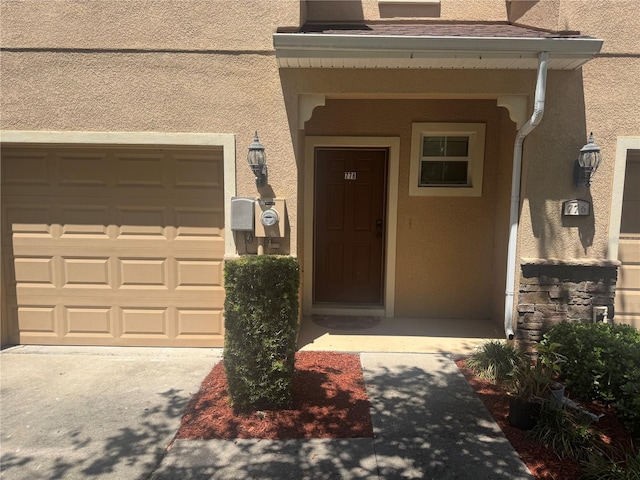 778 Spring Flowers Trl, Brandon, FL 33511 - entrance to property featuring driveway, a garage, and stucco siding
