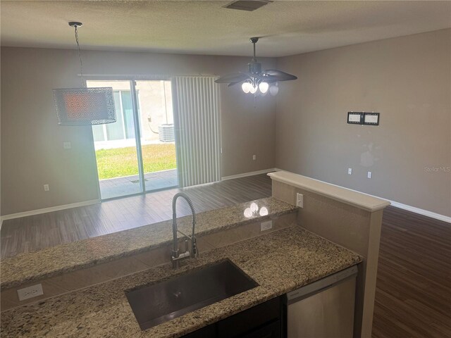 778 Spring Flowers Trl, Brandon, FL 33511 - kitchen featuring light stone counters, dishwasher, a sink, baseboards, and dark wood-type flooring