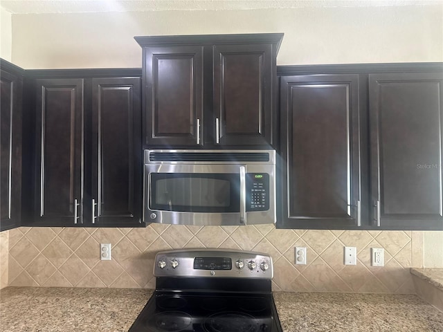 778 Spring Flowers Trl, Brandon, FL 33511 - kitchen with light stone countertops, backsplash, and appliances with stainless steel finishes