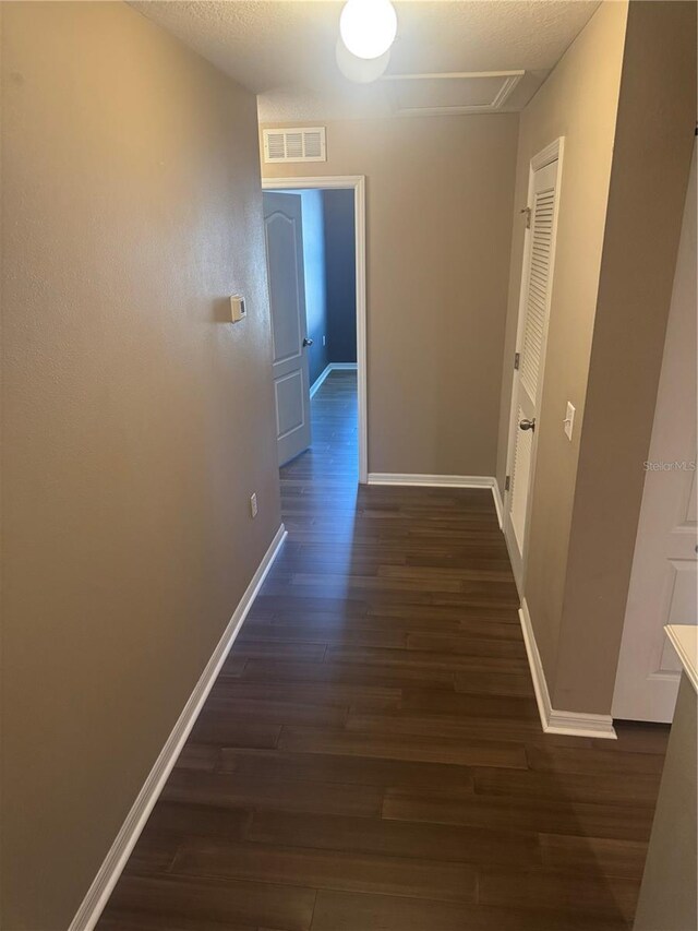 778 Spring Flowers Trl, Brandon, FL 33511 - hall featuring dark wood-style floors, visible vents, and baseboards