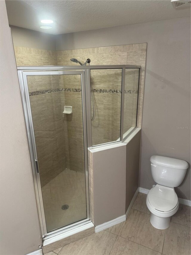 778 Spring Flowers Trl, Brandon, FL 33511 - full bath with tile patterned floors, a shower stall, toilet, baseboards, and visible vents
