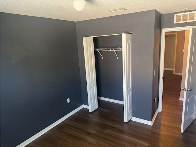 778 Spring Flowers Trl, Brandon, FL 33511 - unfurnished bedroom featuring dark wood-style flooring, visible vents, and baseboards