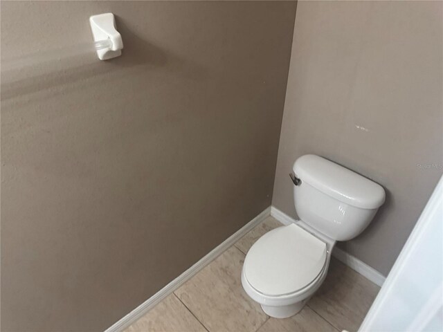 778 Spring Flowers Trl, Brandon, FL 33511 - bathroom with baseboards, toilet, and tile patterned flooring