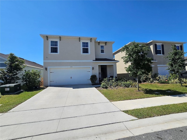 traditional-style home with stucco siding, an attached garage, concrete driveway, and a front yard