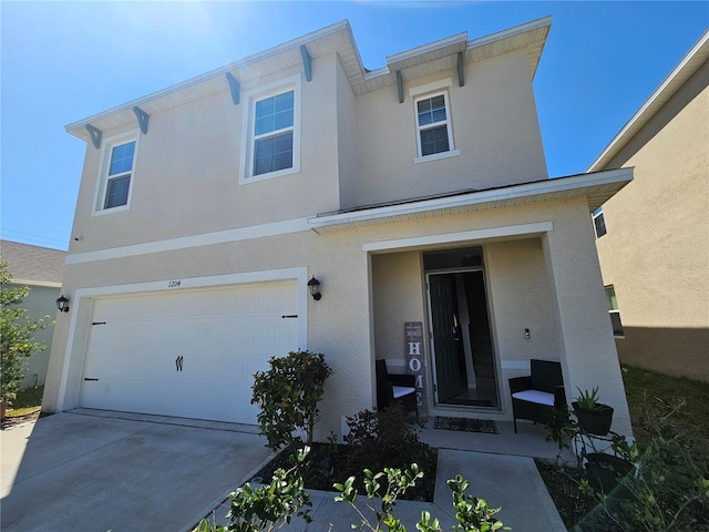 traditional home featuring stucco siding, an attached garage, and driveway