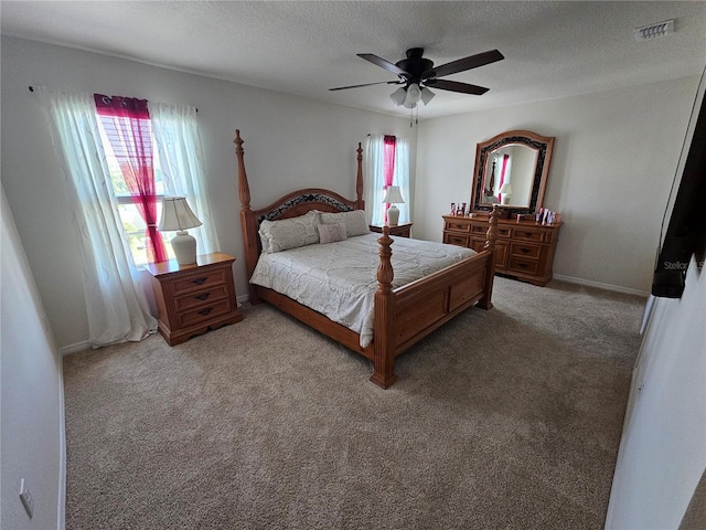 bedroom with visible vents, light carpet, a ceiling fan, and multiple windows