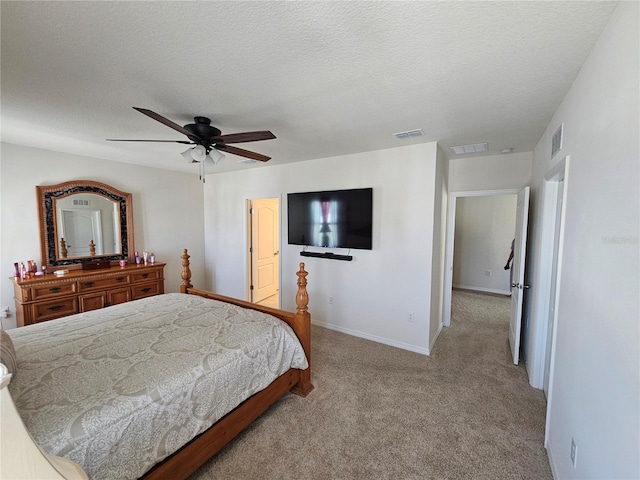 carpeted bedroom with visible vents, a ceiling fan, and baseboards