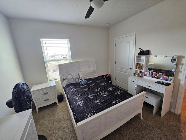 carpeted bedroom featuring ceiling fan and a textured ceiling