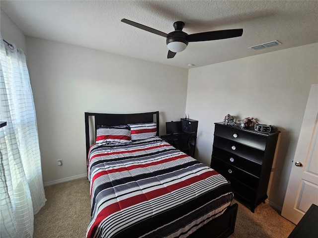 bedroom with visible vents, carpet flooring, baseboards, and a ceiling fan