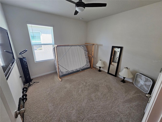 unfurnished bedroom with carpet floors, baseboards, and ceiling fan