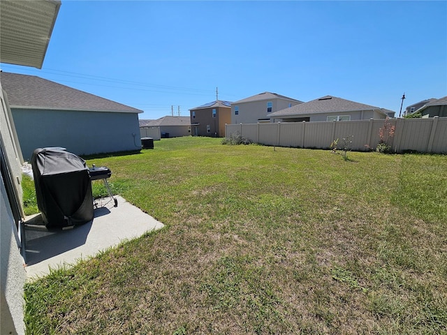 view of yard with fence and a patio