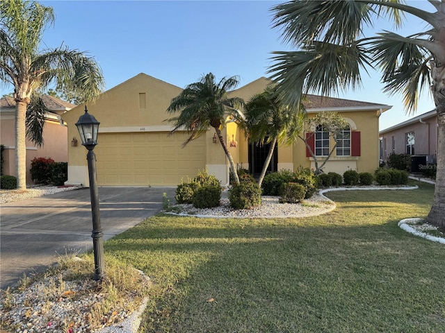 446 Noble Faire Dr, Sun City Center, FL 33573 - view of front facade featuring stucco siding, driveway, a front yard, and a garage