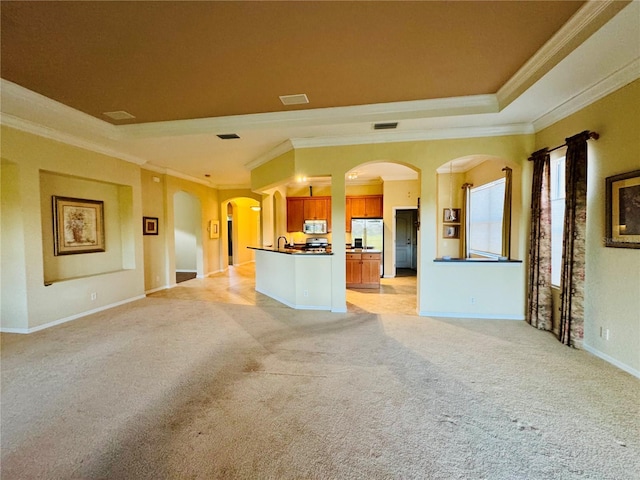 446 Noble Faire Dr, Sun City Center, FL 33573 - unfurnished living room with baseboards, ornamental molding, arched walkways, and light carpet