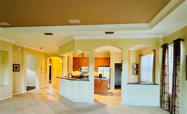 446 Noble Faire Dr, Sun City Center, FL 33573 - kitchen featuring appliances with stainless steel finishes, dark countertops, light carpet, visible vents, and crown molding
