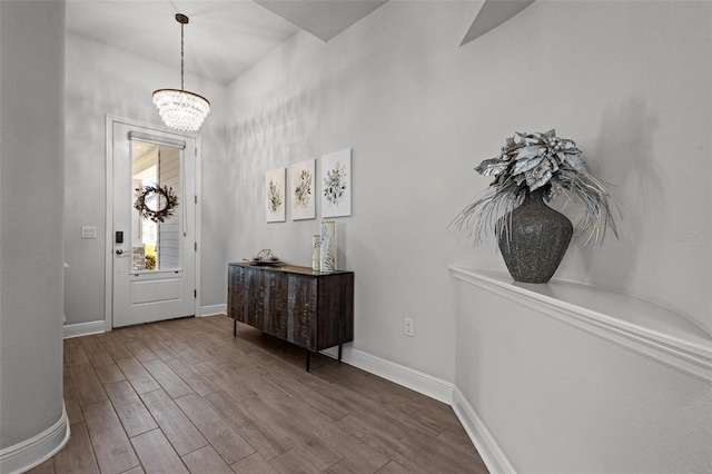 15329 Renaissance Ave, Odessa, FL 33556 - foyer entrance with baseboards, wood finished floors, and an inviting chandelier