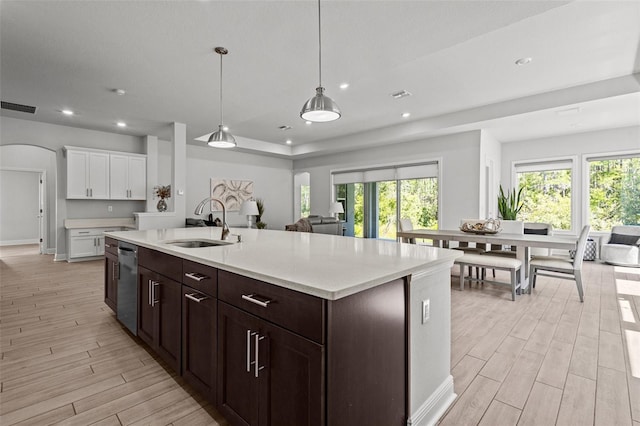 15329 Renaissance Ave, Odessa, FL 33556 - kitchen with light wood finished floors, open floor plan, stainless steel dishwasher, and visible vents