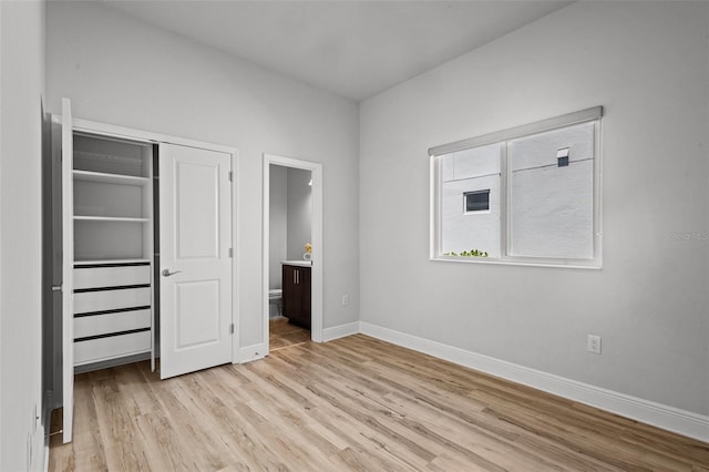 15329 Renaissance Ave, Odessa, FL 33556 - unfurnished bedroom featuring light wood-type flooring, a closet, baseboards, and connected bathroom